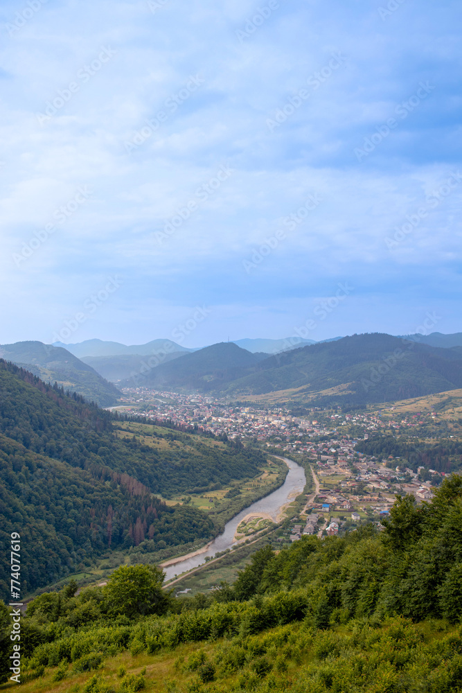 Carpathian Mountains, Ukraine. Carpathian view of a mountain river and village Carpathian Mountains, Ukraine. Carpathian view of a mountain river and village