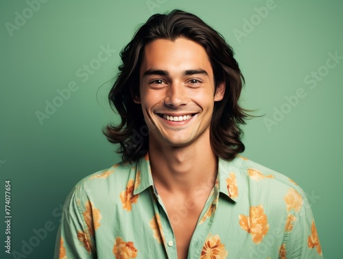 A man with a bright color shirt is smiling and laughing
