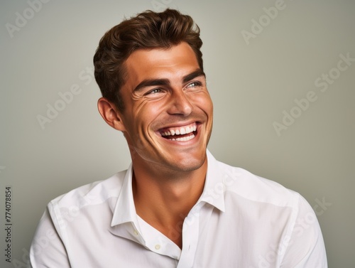 A man with a bright color shirt is smiling and laughing