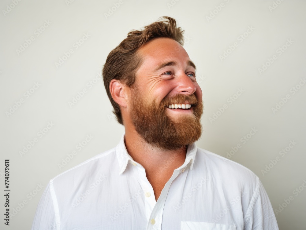 A man with a bright color shirt is smiling and laughing A man with a bright color shirt is smiling and laughing