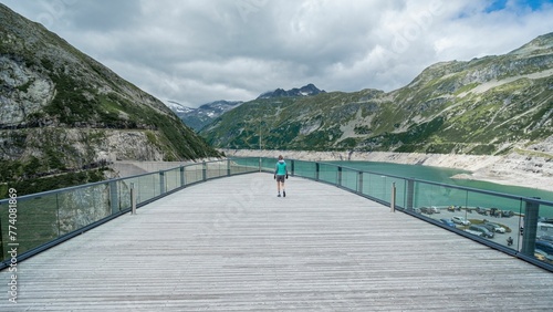 Terrace view from the mountain hotel at Kolnbrein dam a man walking on, Austria photo