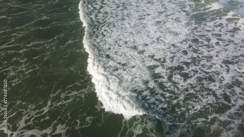 Aerial view of the splashing waves of the sea on a gloomy day Aerial view of the splashing waves of the sea on a gloomy day