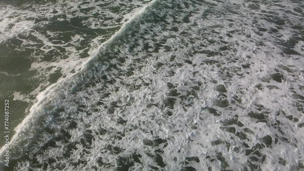 Aerial view of the splashing waves of the sea on a gloomy day Aerial view of the splashing waves of the sea on a gloomy day