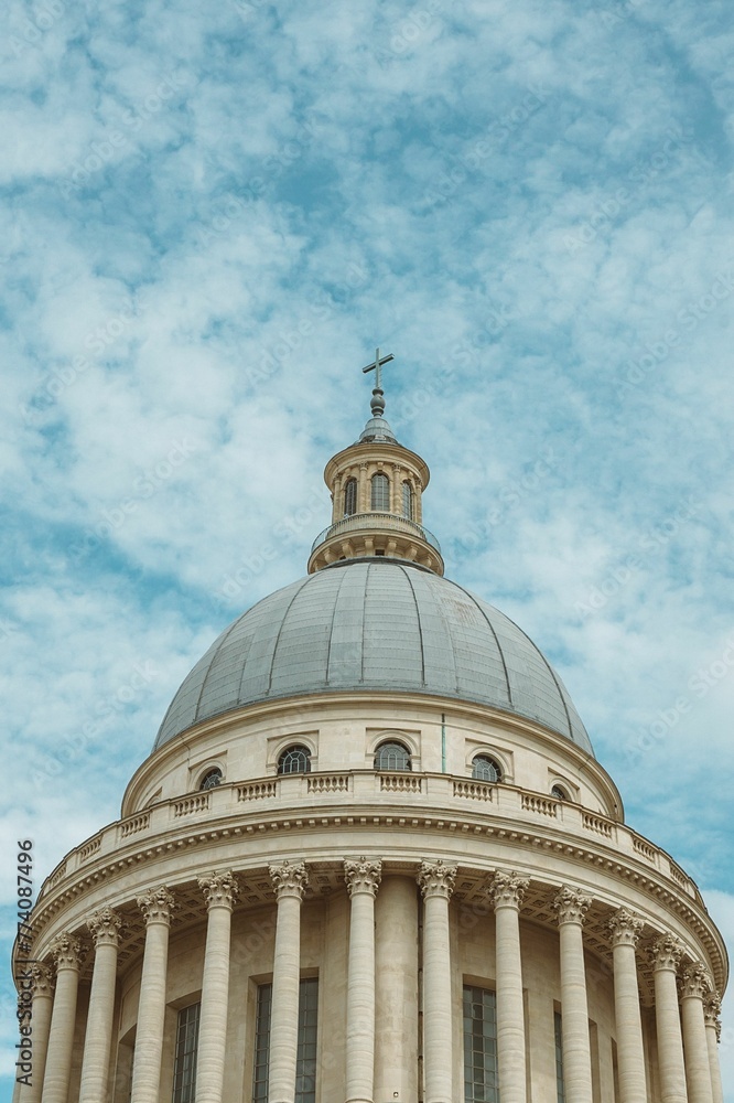Vertical low-angle of the Pantheon monument dome against cloudy sky background