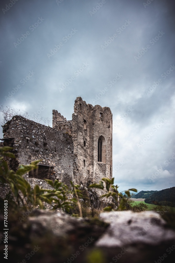 Ruins of a medieval castle under the gloomy sky