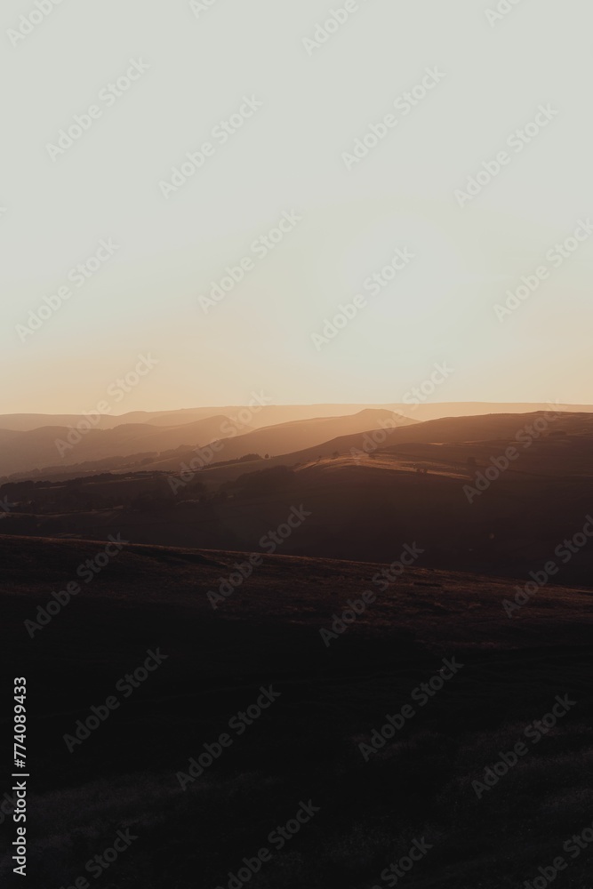 Vertical shot of sunset over Stanage Edge in Peak District, England