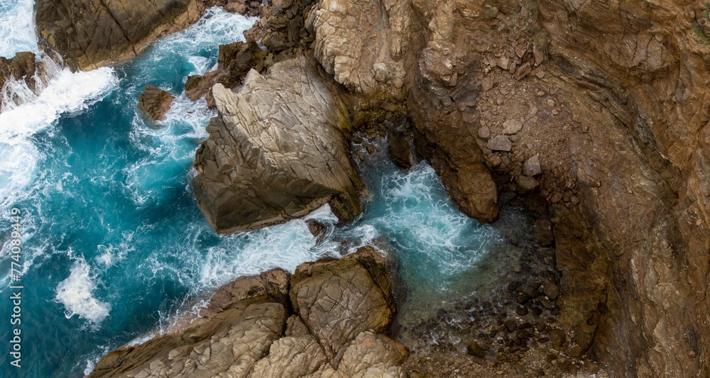 Brown cliffs and beautiful turquoise sea waves. Brown cliffs and beautiful turquoise sea waves.