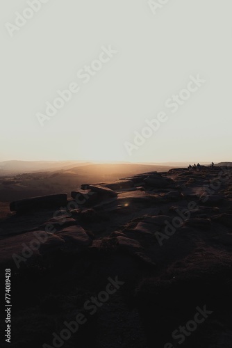 Vertical shot of the mesmerizing sunset over the rocky hillside