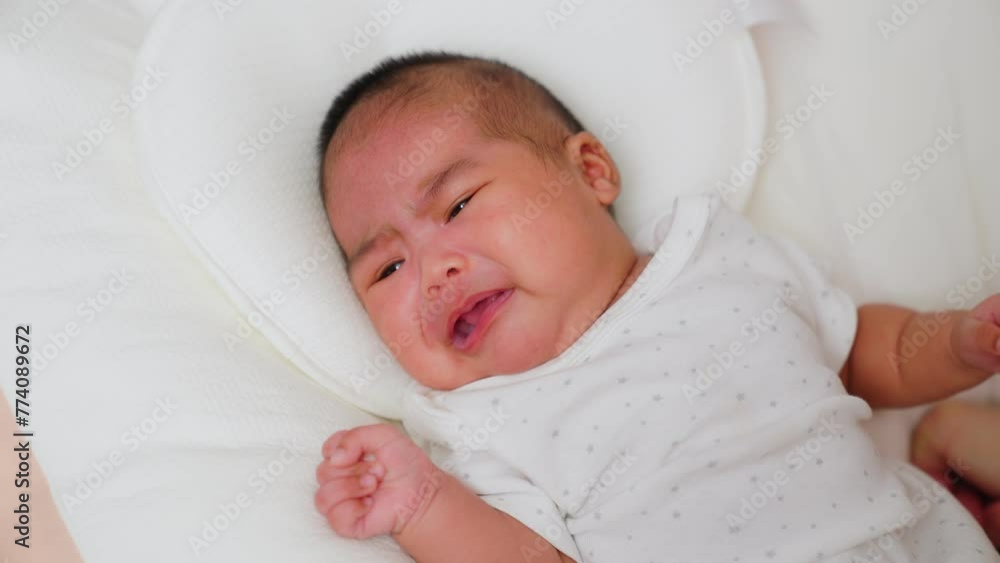 Asian mother gives a pacifier dummy to mouth infant baby girl on a bed. newborn sleeping home. Child crying. Pacifiers calm babies. childhood resting. parenthood, life, love, fatherhood, family. Asian mother gives a pacifier dummy to mouth infant baby girl on a bed. newborn sleeping home. Child crying. Pacifiers calm babies. childhood resting. parenthood, life, love, fatherhood, family.