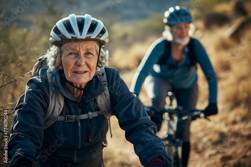 A man and woman equipped with helmets ride bicycles down a dirt road on a cycling adventure