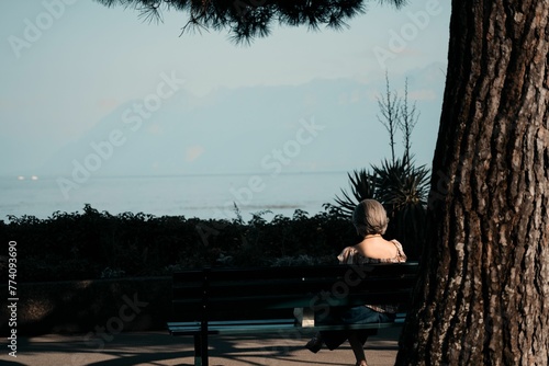 Female sitting on a bench in the evening