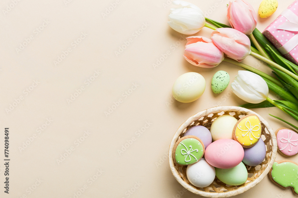 Easter frame with eggs, gift box and tulip on a colored background. The minimal concept. Top view Happy Easter composition. Card with a copy space of the place for the text Easter frame with eggs, gift box and tulip on a colored background. The minimal concept. Top view Happy Easter composition. Card with a copy space of the place for the text