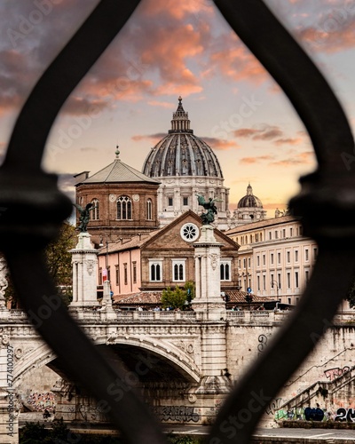 Vertical view from a fence to the St. Peter's Basilica at sunset