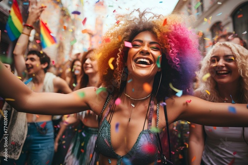 Candid shot of a lively group of friends dancing together during a gay pride celebration, surrounded by colorful decorations.
