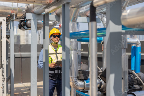 HVAC technician analyzes mechanical, electrical, plumbing systems with energy efficiency plan