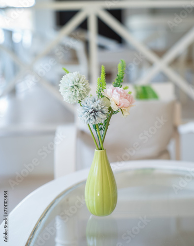 Fake flowers in a vase on table