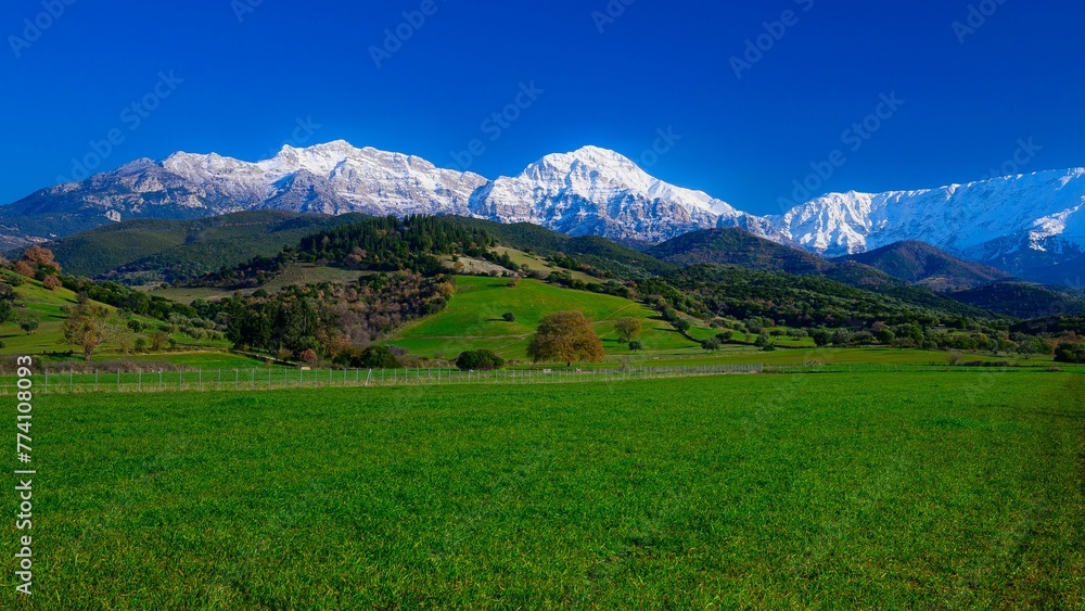 Erymanthos mountain range covered in snow during sunny winter day