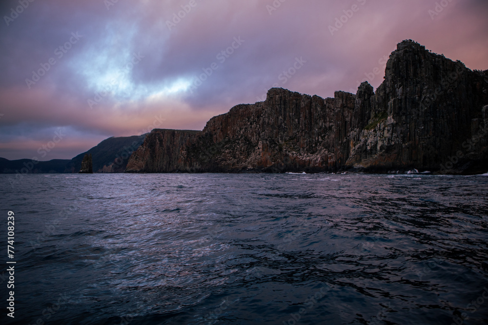 View of the rocky cliffs in the water at sunrise in Cape Hauy Tasmania