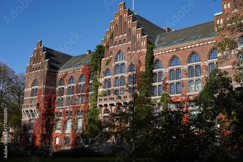 Lund University building exterior with red and green vines in autumn. photo