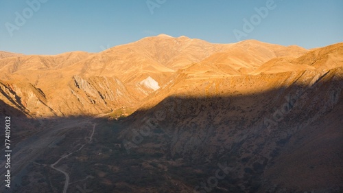 Aerial view of arid hills under bright sunlight in Jujuy province, Argentina