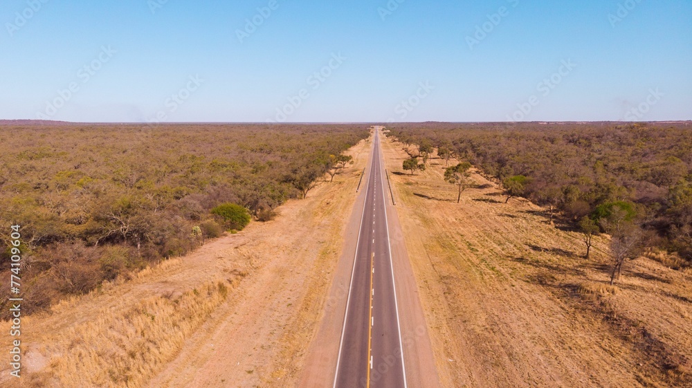 Aerial view of a highway road in the middle of the field