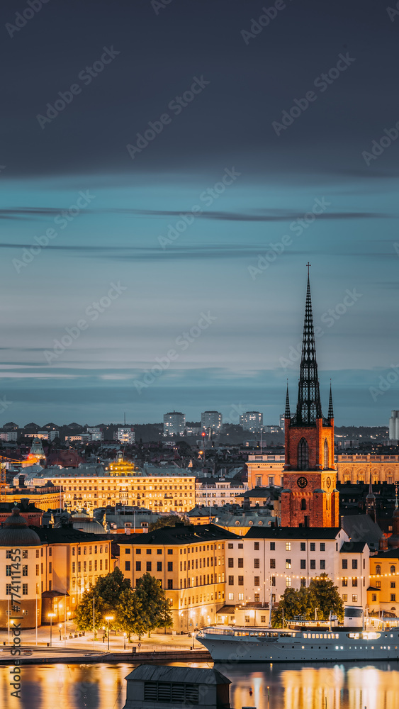 Stockholm, Sweden. Scenic View Of Stockholm Skyline At Summer Evening. Famous Popular Destination Scenic Place In Dusk Lights. Riddarholm Church In Night Lighting.