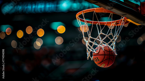 Sport action photography. A basketball going through the net in an indoor setting