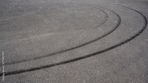 skid marks on a road surface. Circular tire marks left by drivers doing doughnuts