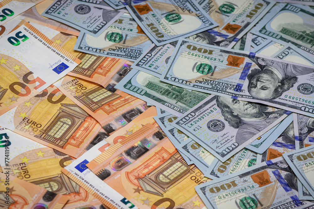 Closeup view of one hundred dollars banknote with euro money banknotes around as financial background.3 Closeup view of one hundred dollars banknote with euro money banknotes around as financial background.3