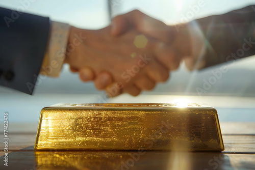 Gold bar on the table and businessman handshake, Investing or trading and exchanging gold both domestically and internationally, demand and supply on gold photo