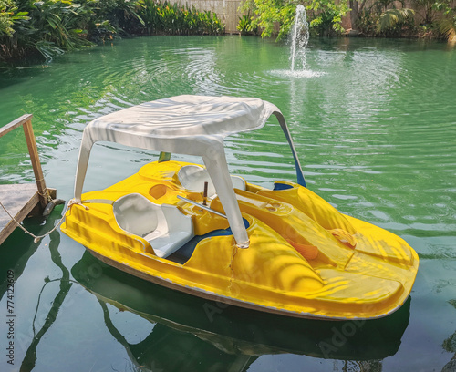 yellow pedal boat in water park