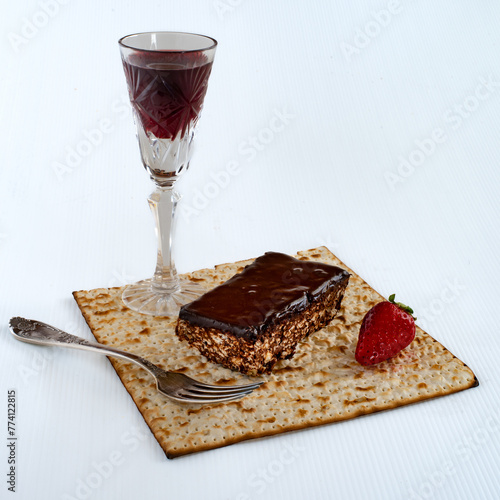 Home made Matzot chocolate cake, red wine glass and strawberry for Passover holidays.