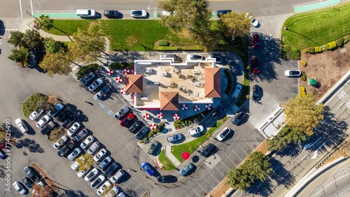 Fast Food Restaurant Cars in Drive Thru. Top Down Aerial Time Lapse View in Day.