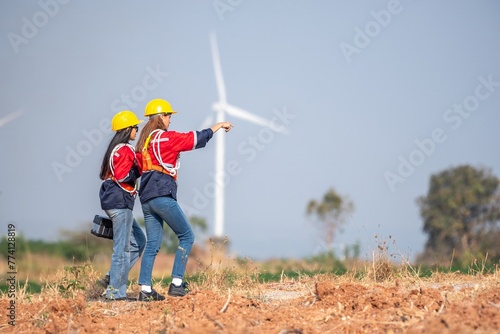 couple engineer team inspection check control wind power machine construction installation in wind energy factory. Two technician professional worker discussion for maintenance wind power turbine