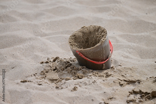 A bucket full of sand at the beach of Benidorm-Spain.