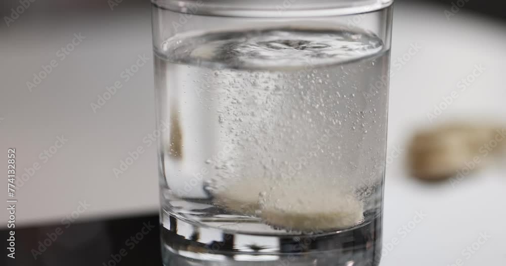 Medical soluble tablet in glass of water. Medical effervescent medicine for headache concept Medical soluble tablet in glass of water. Medical effervescent medicine for headache concept