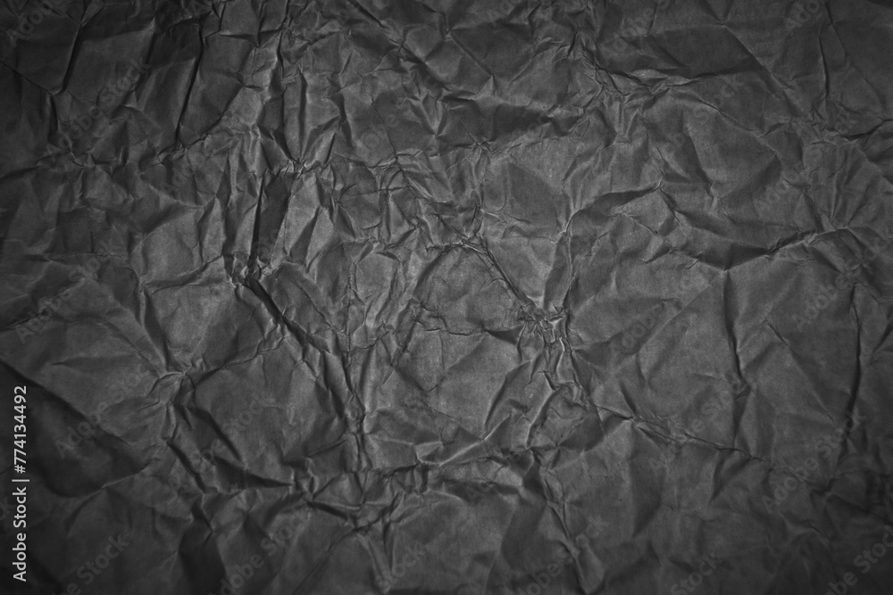 Fototapeta premium Crumpled black paper texture background for graphic design and web design