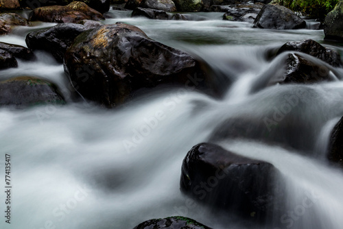 Stream water long exposure shot with rocks © Johnster Designs