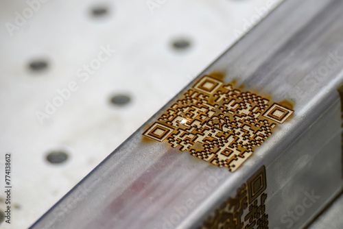 Close up scene the laser masking QR code on square tube.