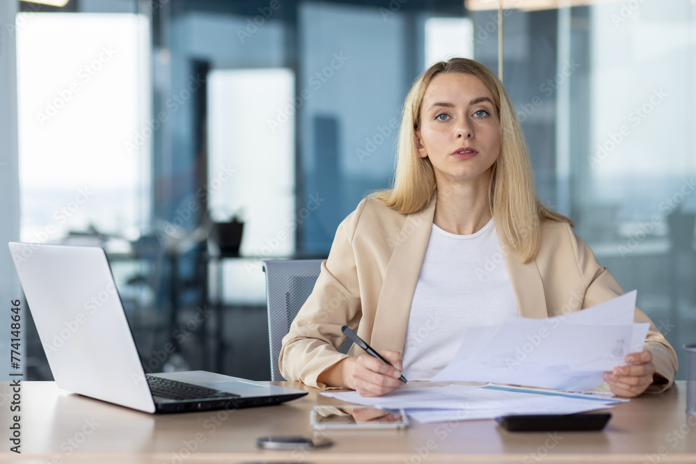 Professional businesswoman working at office desk Professional businesswoman working at office desk