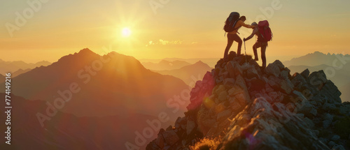 In a display of camaraderie, two hikers embrace on a mountain crest during sunset, overlooking a vast landscape.