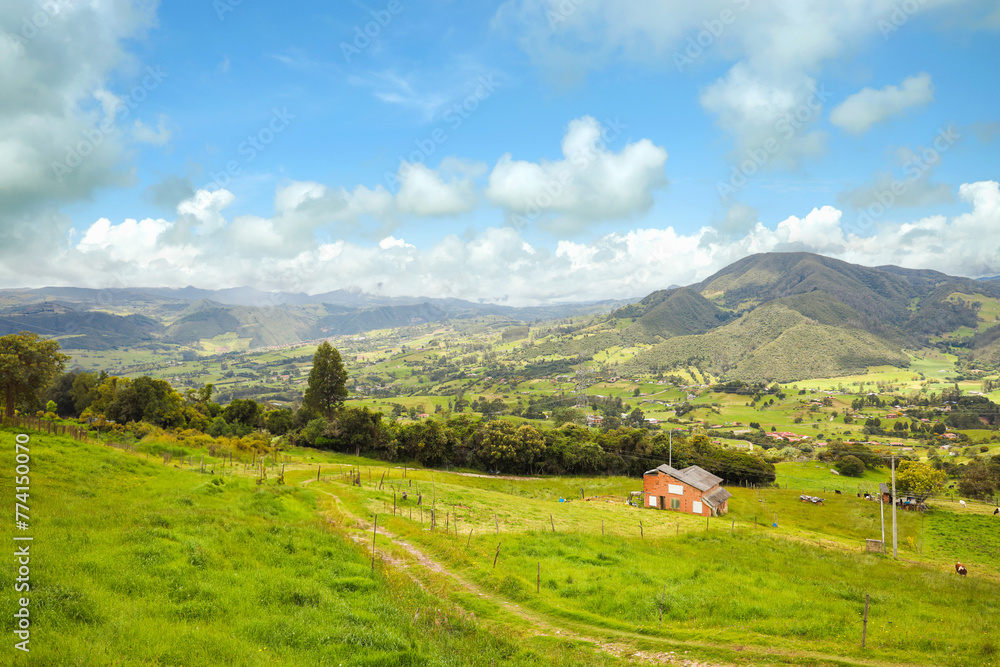 Nice landscape with white clouds blue sky and beautiful fields with mountains in La Calera, Bogota, Colombia
