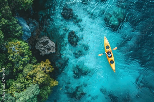 Aerial shot of a person kayaking in clear blue waters near a coral reef, representing adventure with environmental consciousness , advertise photo photo