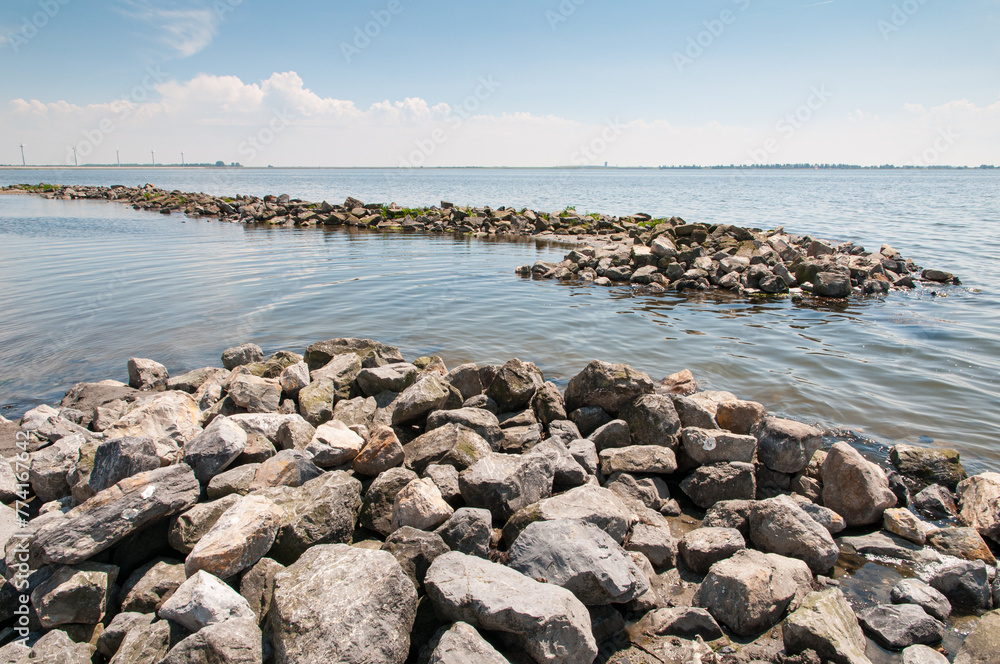  Large boulders forming wave breakers in the Grevelingen lake to protect the little beachnear Battenoord at Goeree-Overflakkee in The Netherlands from the waves.