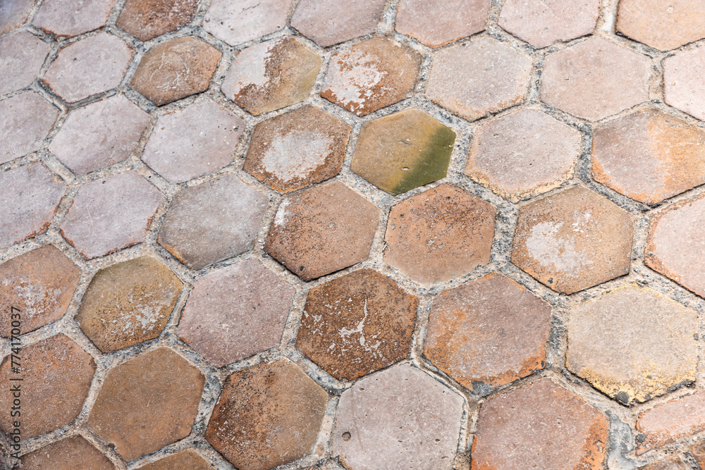 Old road pavement made of hexagonal tiles, background texture Old road pavement made of hexagonal tiles, background texture