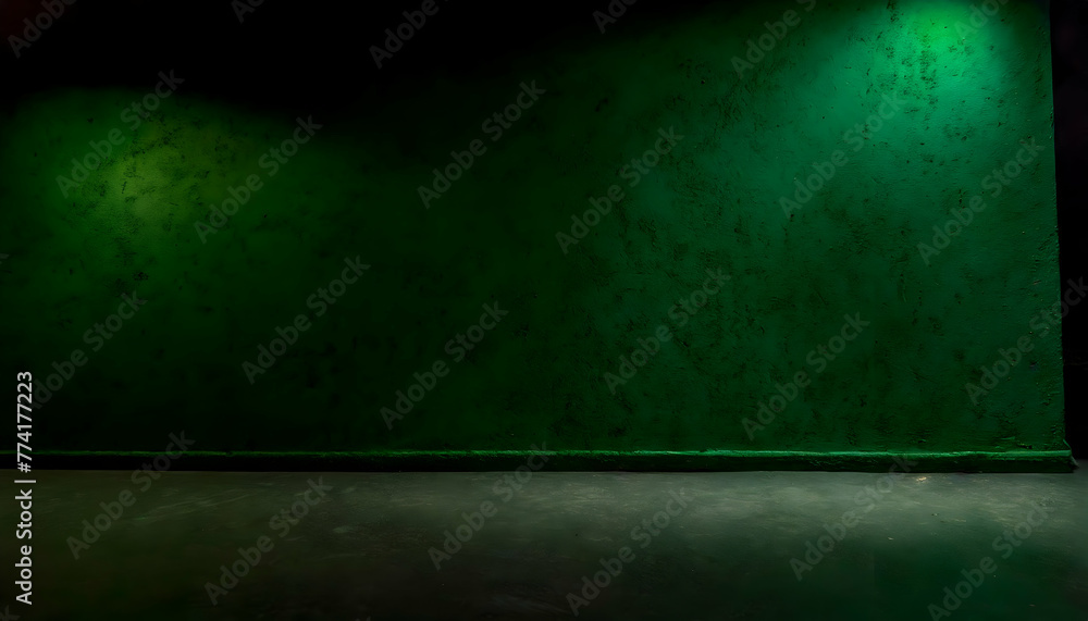Dark green wall in an empty room with a concrete floor at night