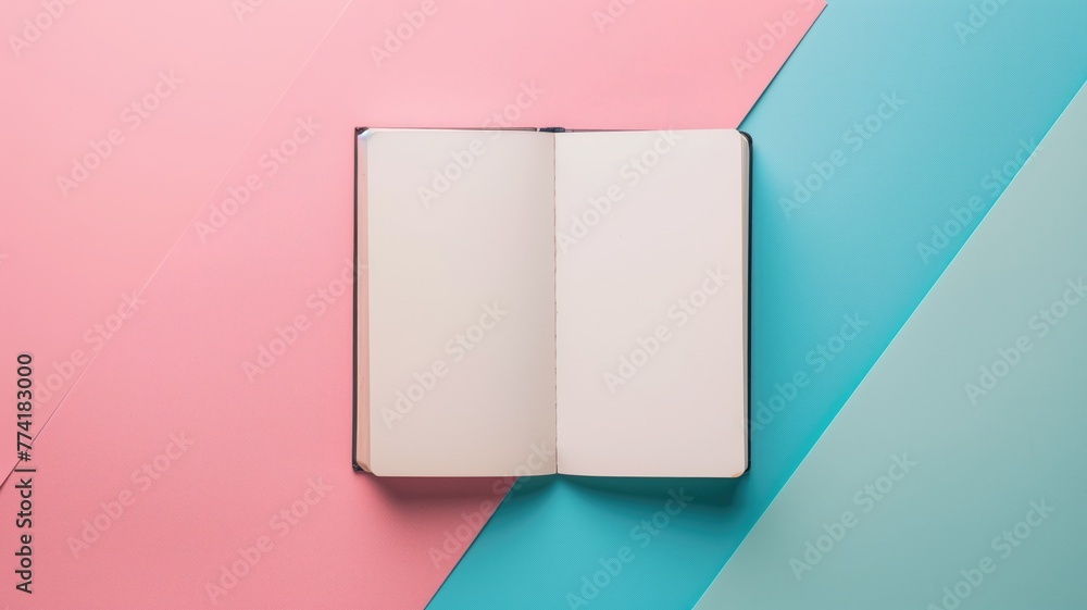 An open blank notebook lies on a pastel pink and blue background, inviting ideas creativity