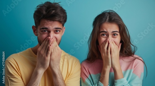 Couple sneezes together in studio on black background photo
