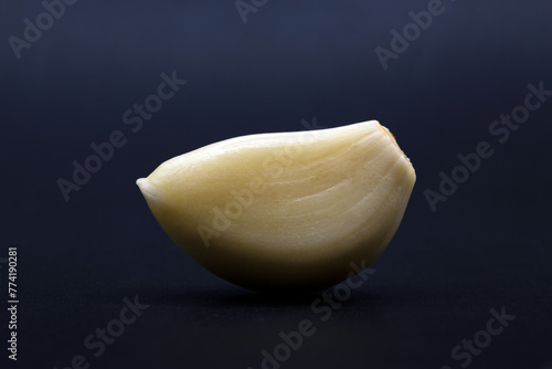 peeled clove of garlic on dark background © nutt