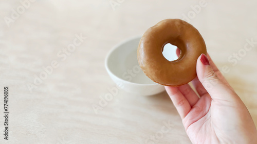 Eating chocolate coated doughnut